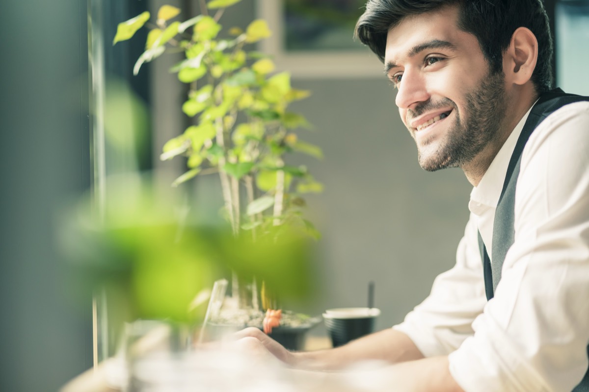 Smiling wellness professional by a window